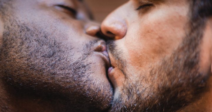 close up of two men kissing