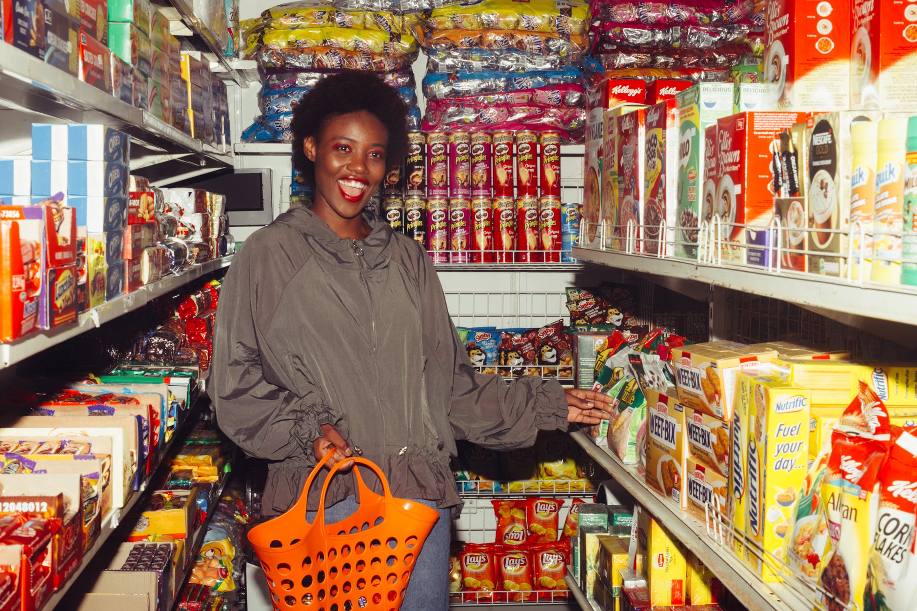 funny black woman choosing food in grocery shop