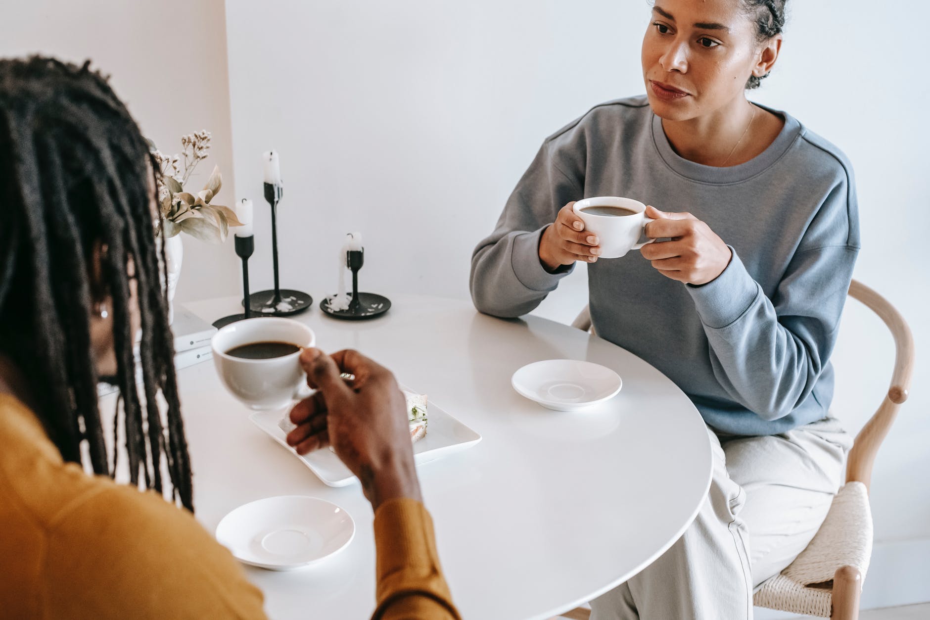 diverse couple drinking coffee together in cafe
