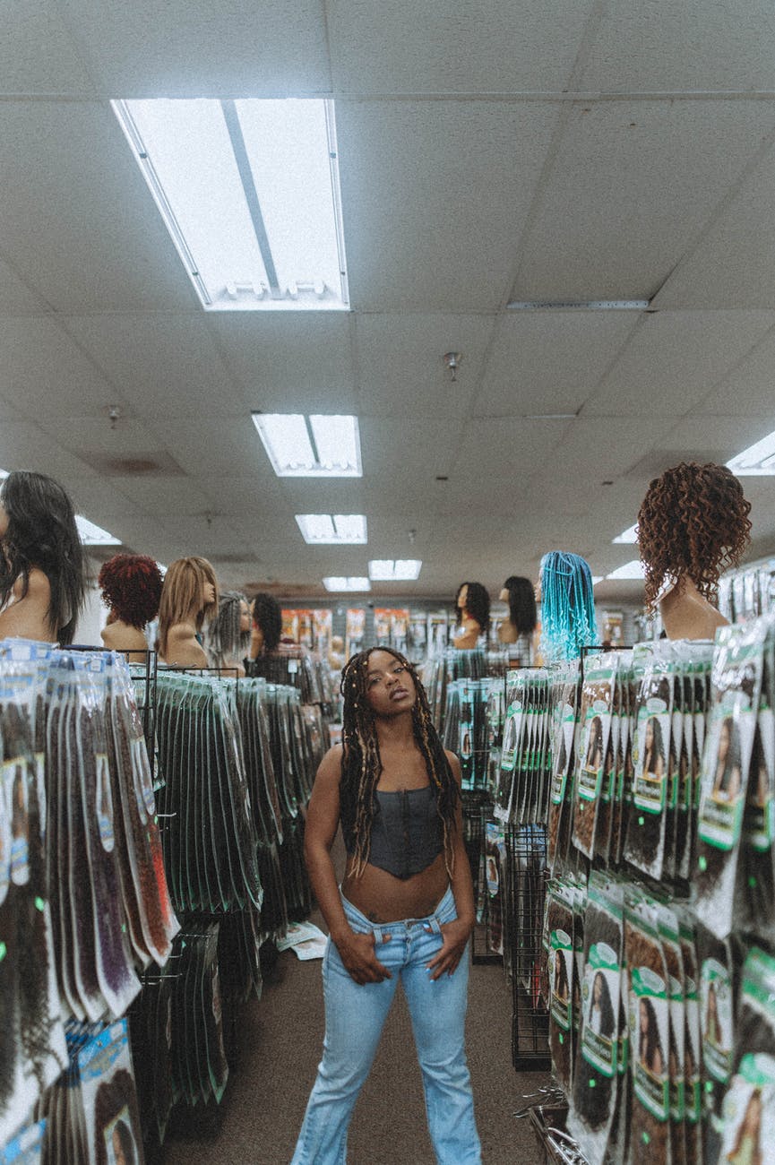 woman in tube top standing on wig shop