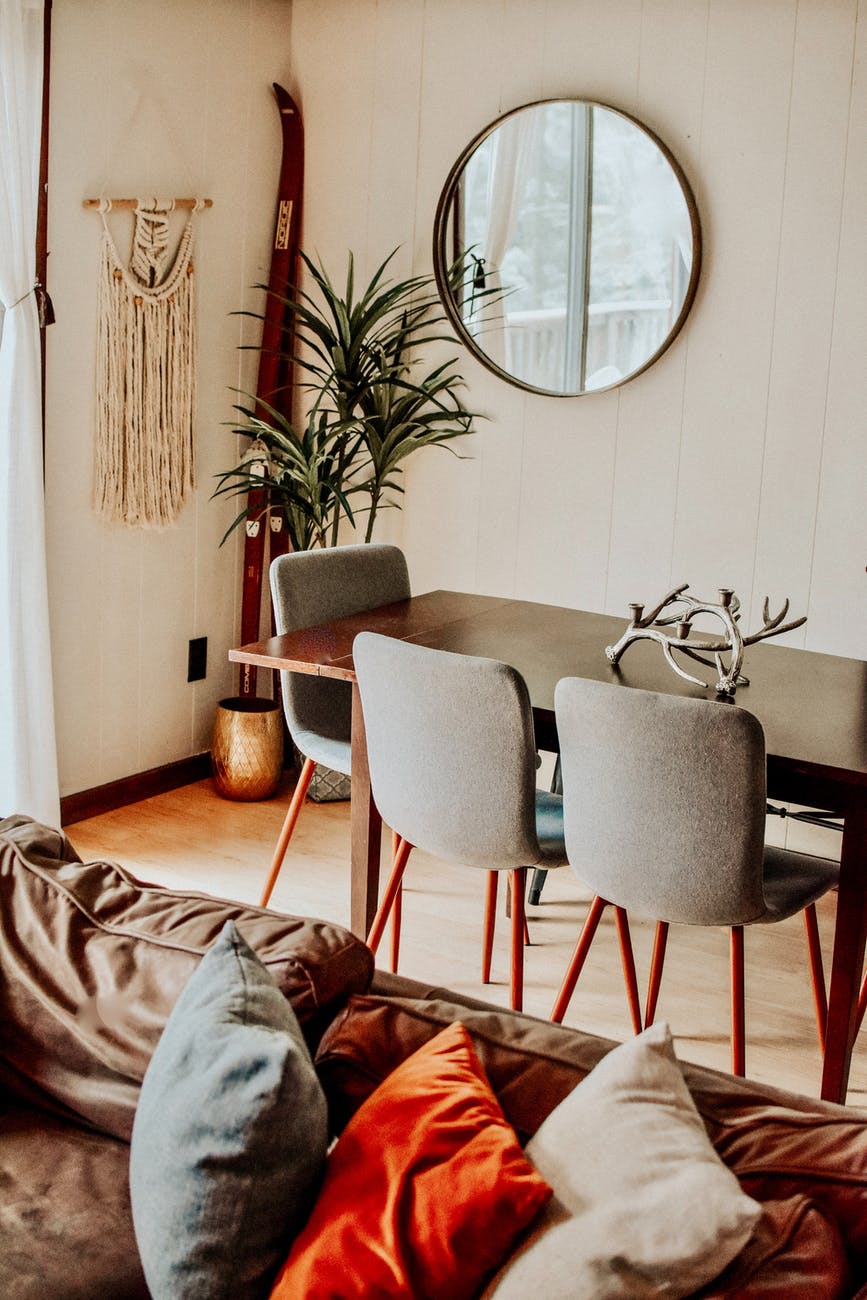 brown wooden framed gray padded armchairs